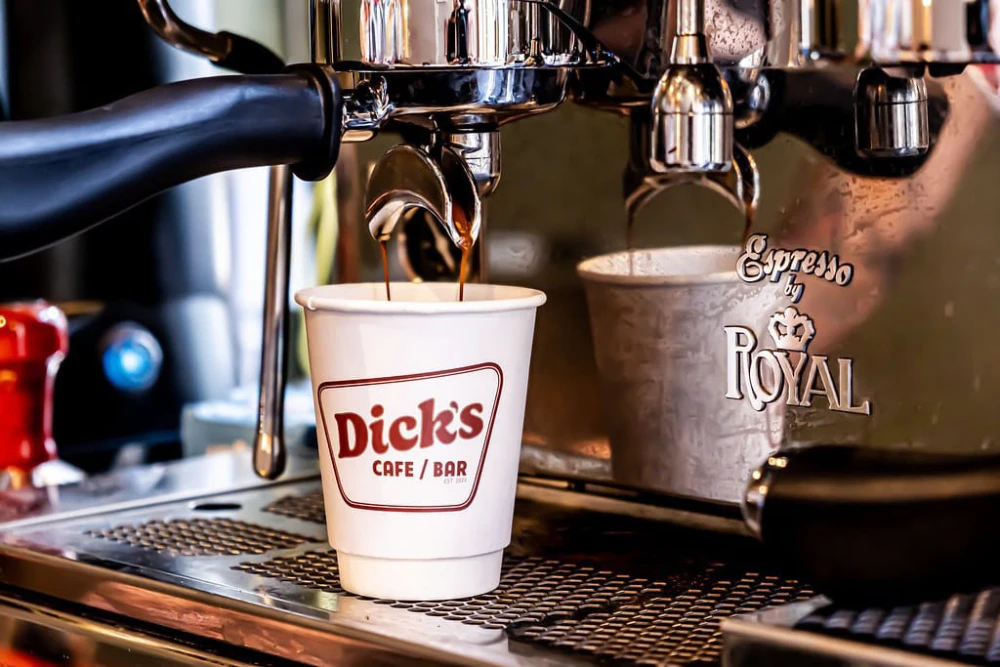 Espresso machine making coffee in Dick's Cafe cup.