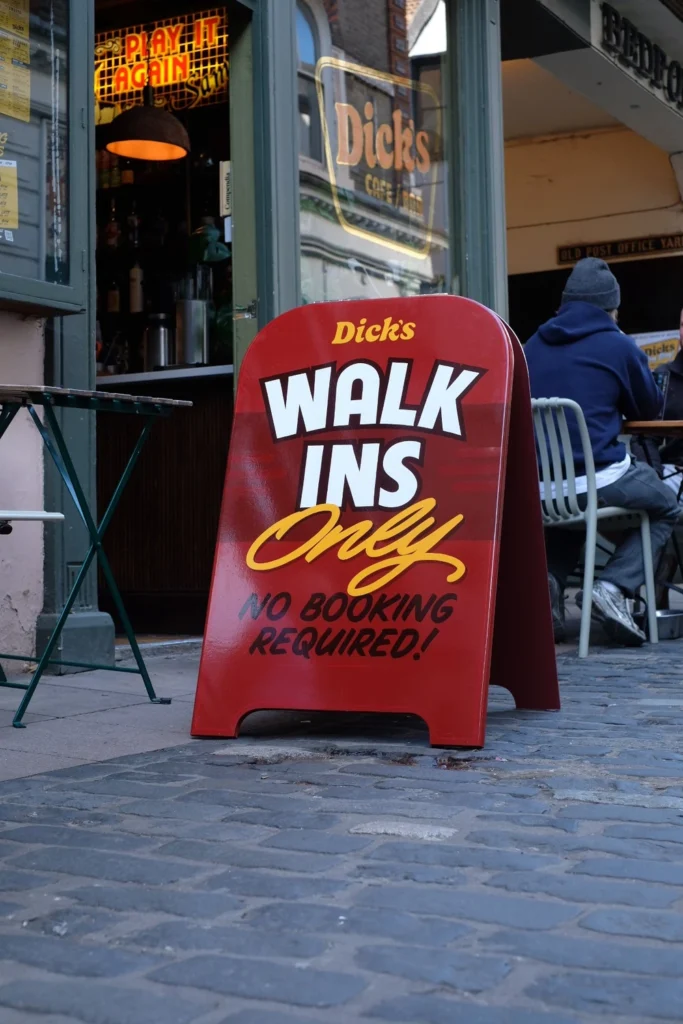Café sign: Walk-ins only, no booking needed.